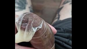 Hidden-dildo play: Lkingsbr fills a condom with semen